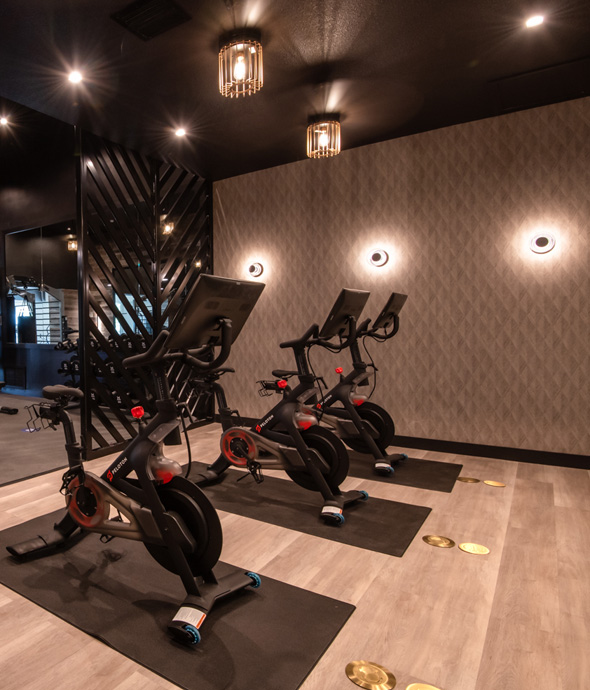 mood lighting fitness workout bike room with three bike aligned