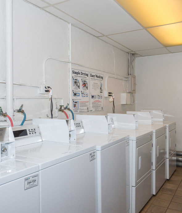 IMT Valleyheart - community electronic washing machines and dyers lined along the wall