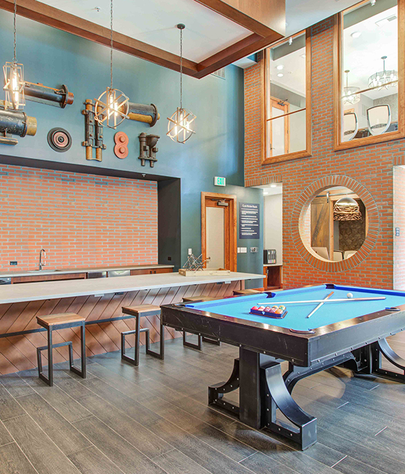 IMT Germantown - Clubhouse with Billiards table, bar seating, with various decorations on the walls