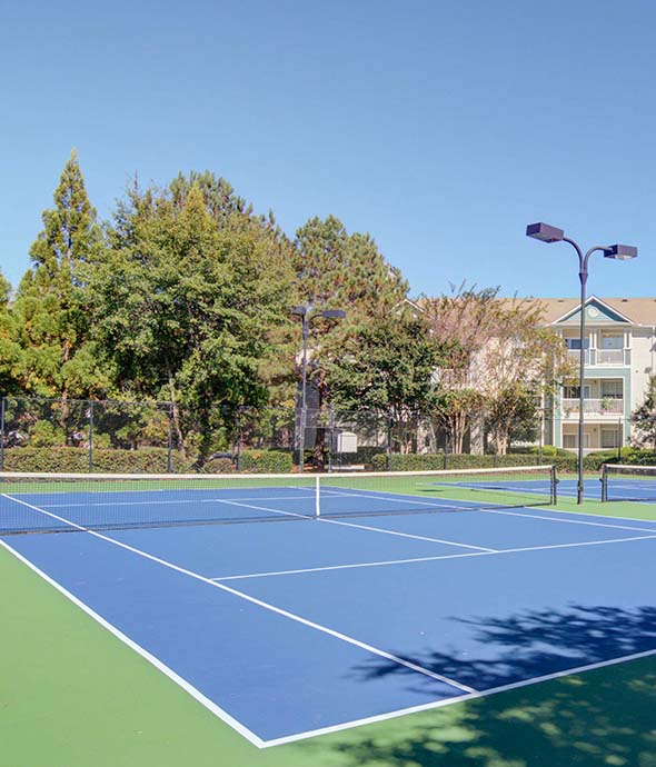 community amenities featuring tennis courts, lighting and outdoor landscape