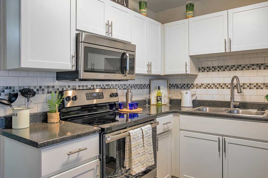 IMT Chandler Kitchen with white cabinets, stainless steel appliances